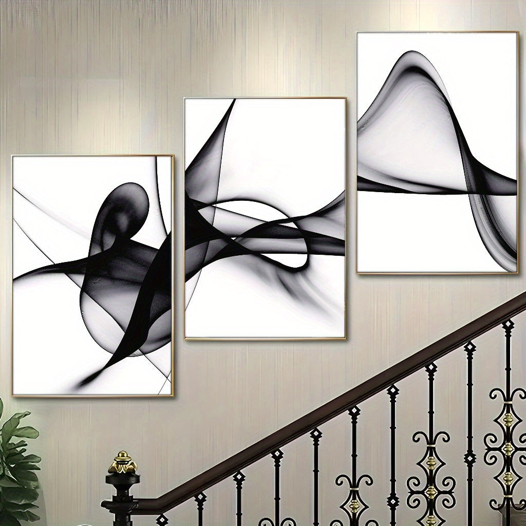 Three pieces of black and white abstract wall art featuring fluid, swirling designs on a light background