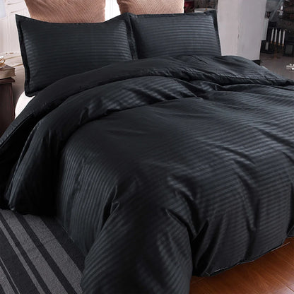Nutshell black satin duvet cover set with striped pattern on bed with matching pillowcases