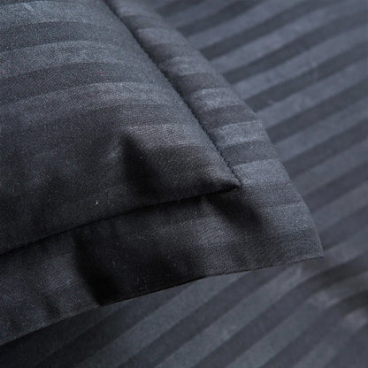 Close-up of black satin duvet cover set with subtle striped pattern and smooth texture