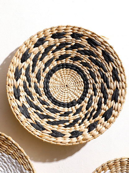 Nutshell round woven bohemian wall decor in natural and black colors with spiral pattern
