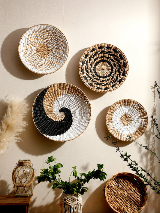 Nutshell bohemian wall decor featuring woven round baskets in natural and black tones mounted on a beige wall