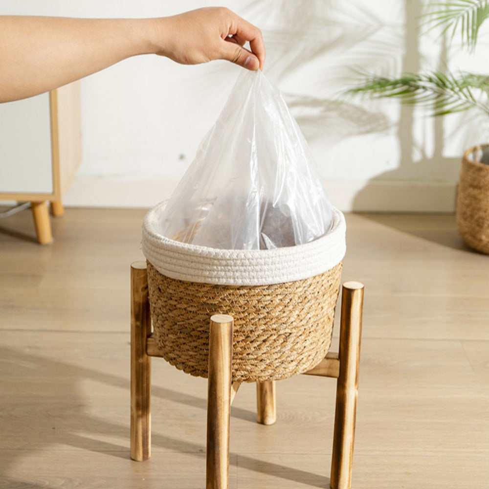 Bohemian Woven Planter With Legs featuring a hand placing a plastic liner inside for easy planting