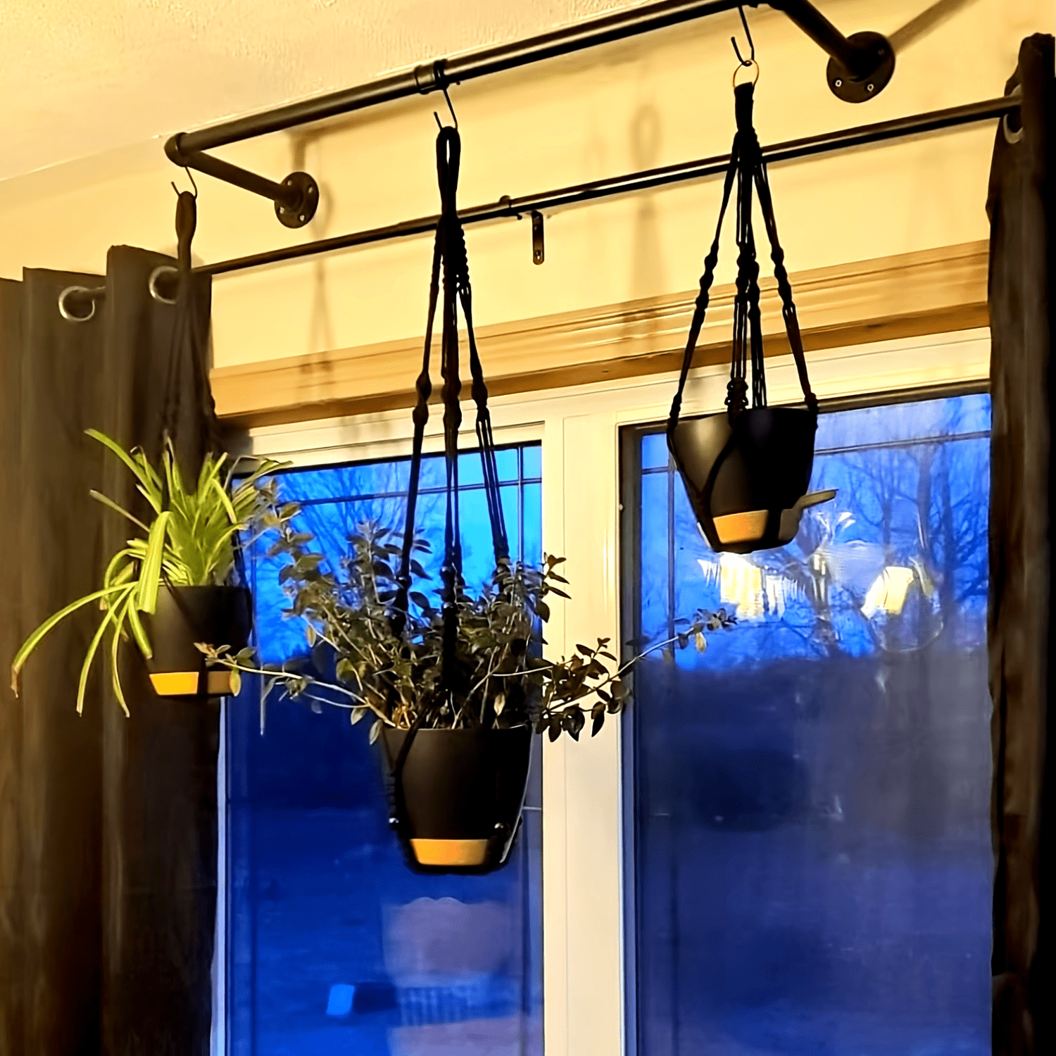 Boho Macrame Plant Hangers Self-Watering Hanging Baskets displayed in a modern home setting with plants