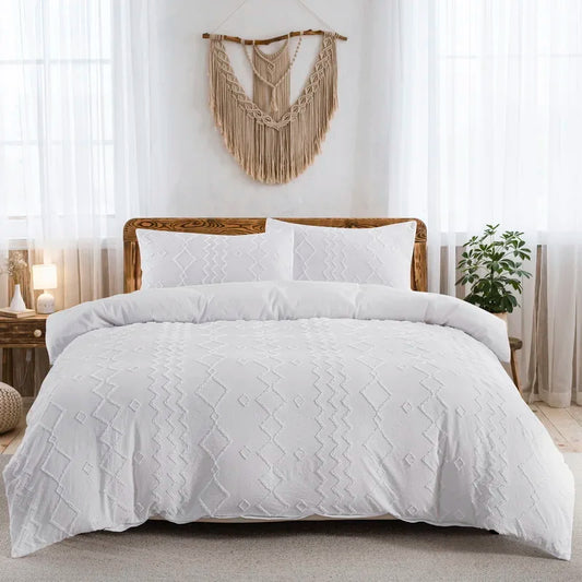 Nutshell boho tufted duvet cover in white on a wooden bed with matching pillow shams and macrame wall decor