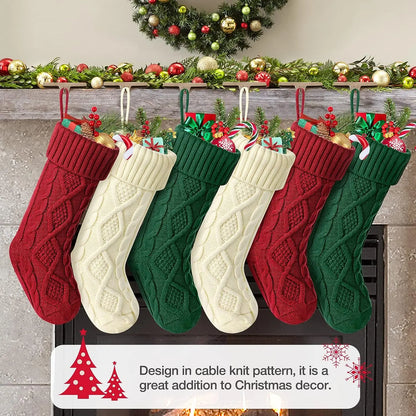 Set of cable knit Christmas stockings in red, green, and cream hanging by a festive fireplace