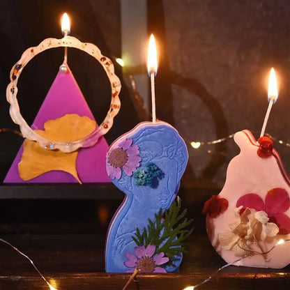 Nutshell decorative candles with lit pre-waxed candle wicks in purple, blue, and pink floral designs