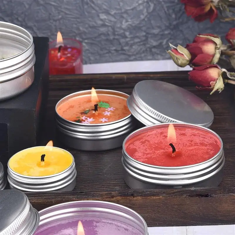 Nutshell colorful candles with pre-waxed candle wicks in metal tins on wooden surface with dried flowers