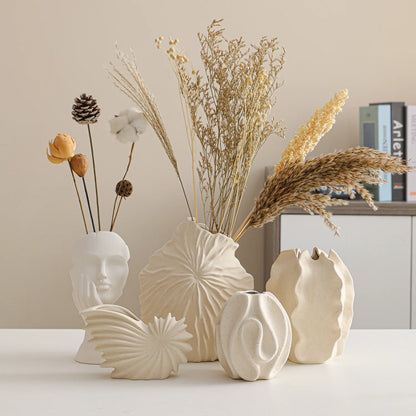Nutshell ceramic conch design vase in beige displayed with dried flowers on a white table