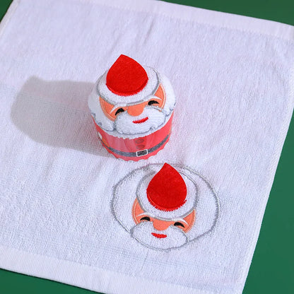 Two Christmas cake shaped hand towels featuring Santa Claus design for festive holiday décor