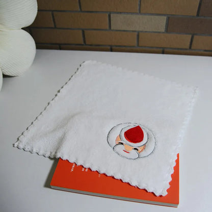 Nutshell Christmas cake shaped hand towels in white with festive red and green accents