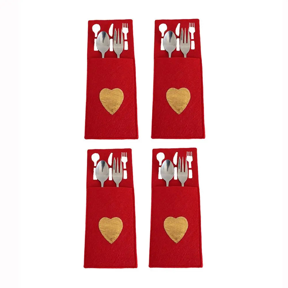 Set of four red Christmas cutlery holders with gold heart accents for festive dining decor