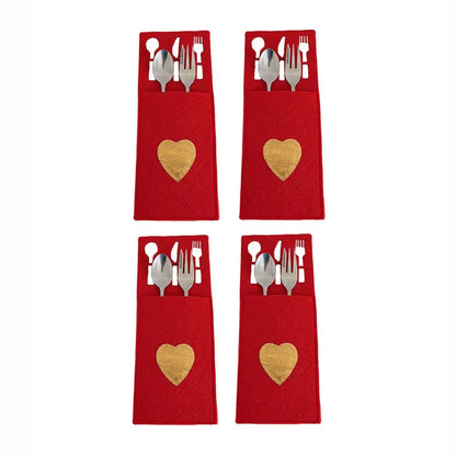 Set of four red Christmas cutlery holders with gold heart accents for festive dining decor
