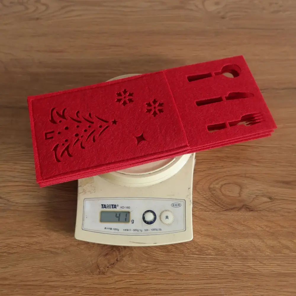 Red felt Christmas cutlery holder with festive designs for holiday dining decor
