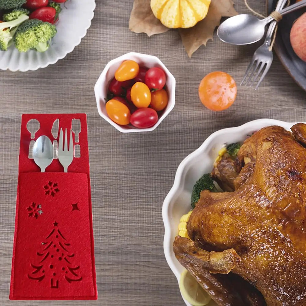 Christmas cutlery holder with tree design alongside a festive holiday table setting