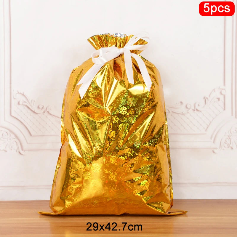 Shiny gold Christmas drawstring gift bags with decorative snowflake design for holiday gifting