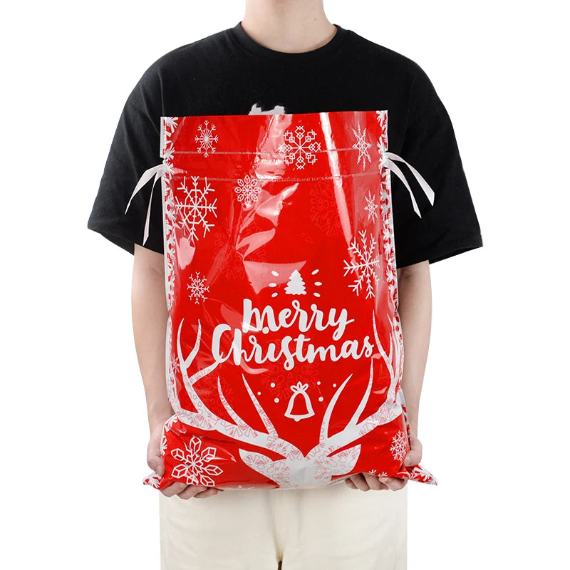 Red Christmas drawstring gift bags featuring festive designs and a cheerful message for holiday gifting