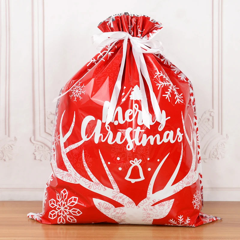 Red Christmas drawstring gift bags with festive snowflake design and Merry Christmas text