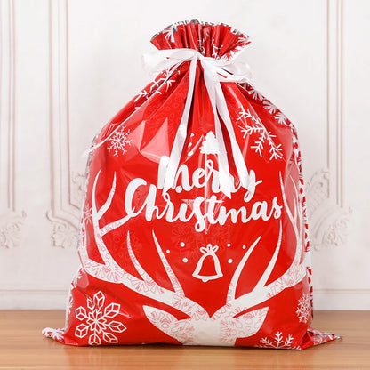Red Christmas drawstring gift bags with festive snowflake design and Merry Christmas text