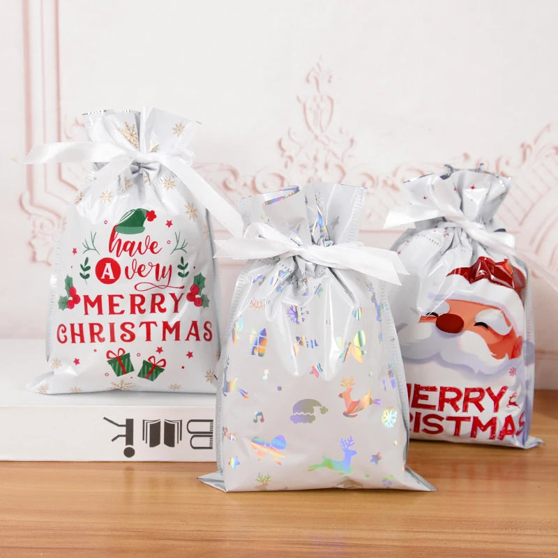Set of three festive Christmas drawstring gift bags featuring colorful holiday designs