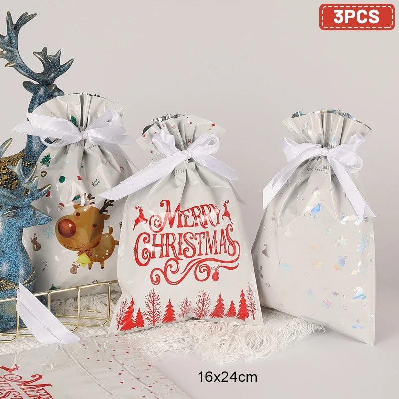 Set of three Christmas drawstring gift bags with festive designs and ribbons, ideal for holiday gifting
