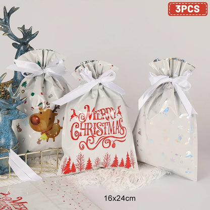 Set of three Christmas drawstring gift bags with festive designs and ribbons, ideal for holiday gifting