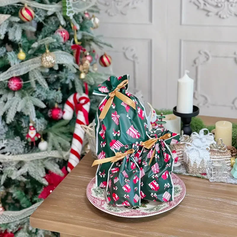 Christmas Drawstring Gift Bags with Ribbon in festive green design on a decorative table