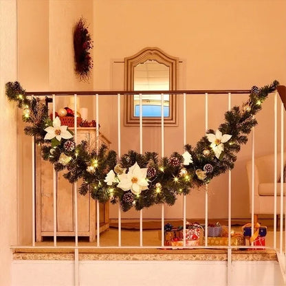 Festive Christmas garland with lights and white flowers, perfect for holiday decorating