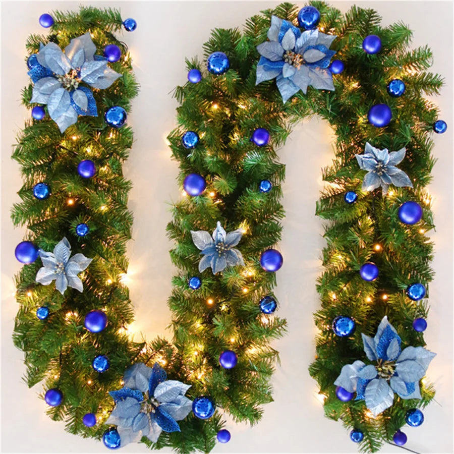 Blue-themed Christmas garland with lights, featuring ornaments and decorative flowers
