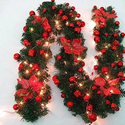 Beautiful Christmas garland with lights featuring red ornaments and festive floral accents