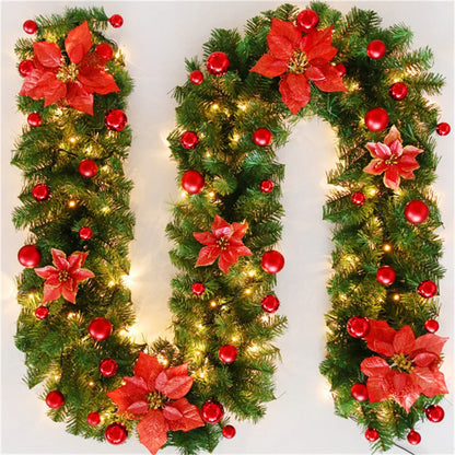 Nutshell Christmas garland with lights featuring red poinsettias and shiny ornaments