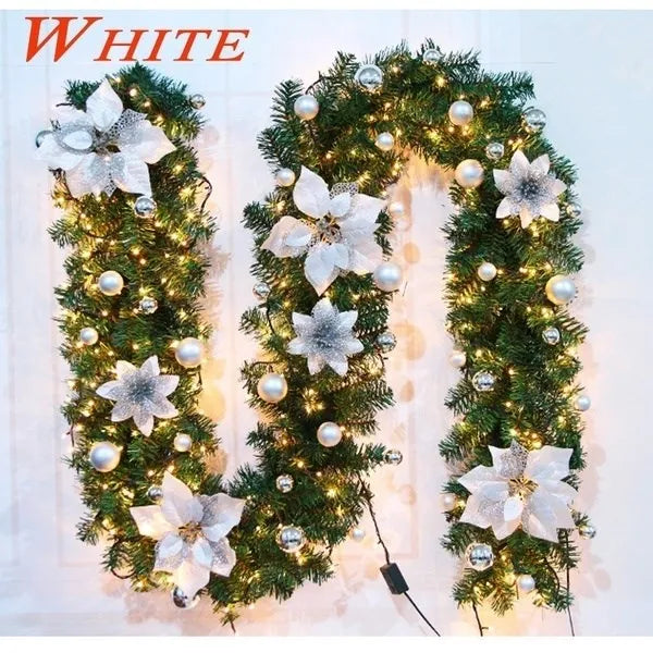 Elegant Christmas garland with lights featuring white flowers and decorative ornaments
