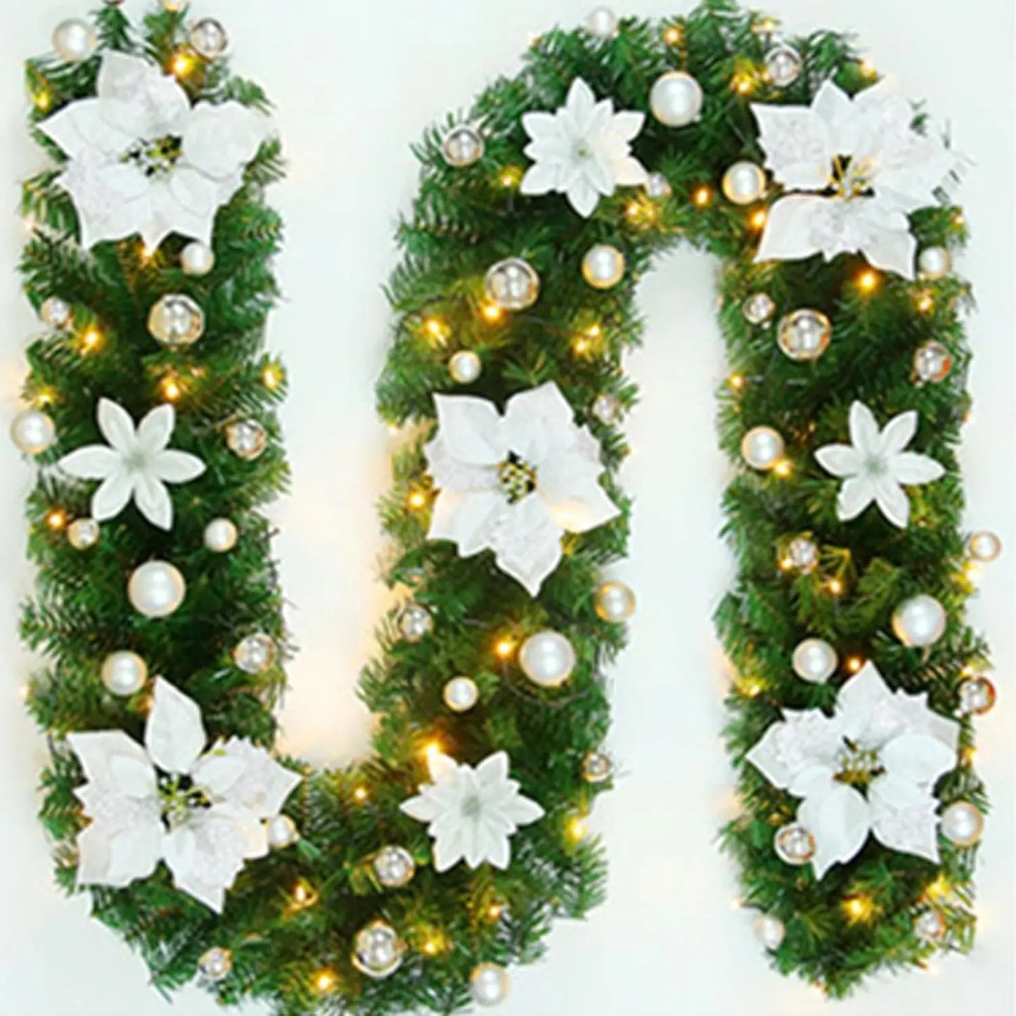 Nutshell Christmas garland with lights featuring white flowers and gold ornaments for festive decoration