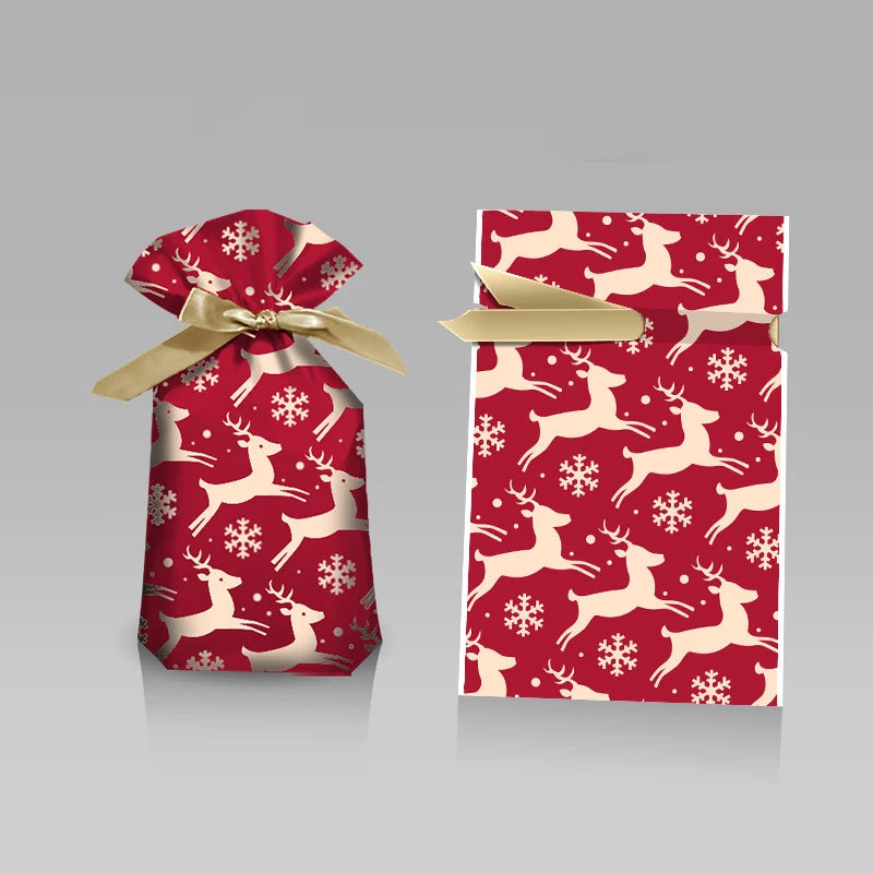 Two festive Christmas gift bags with drawstring in red featuring reindeer and snowflakes