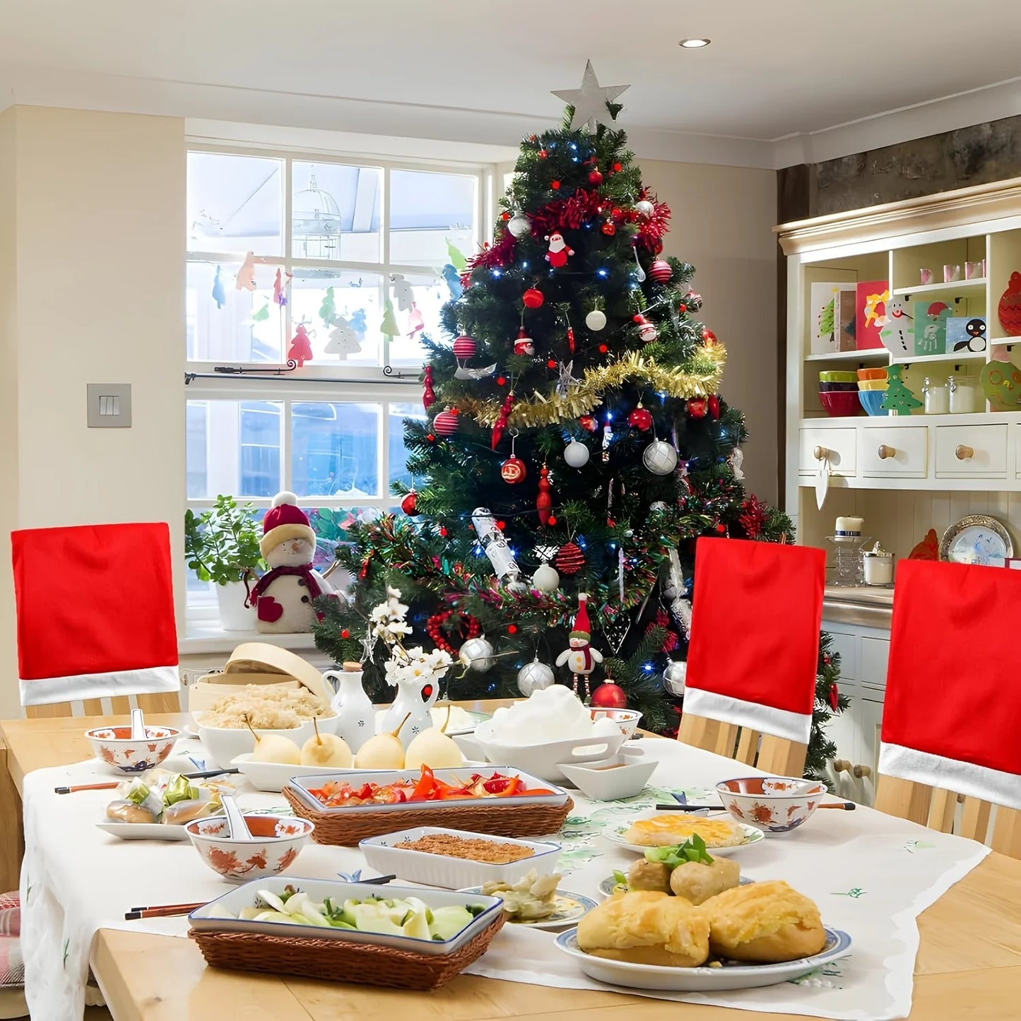 Christmas Hat Chair Covers on dining chairs around a festive table decorated for the holiday season