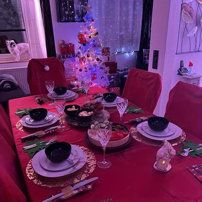 Elegant Christmas dining setup featuring Christmas Hat Chair Covers on red chairs and festive decor