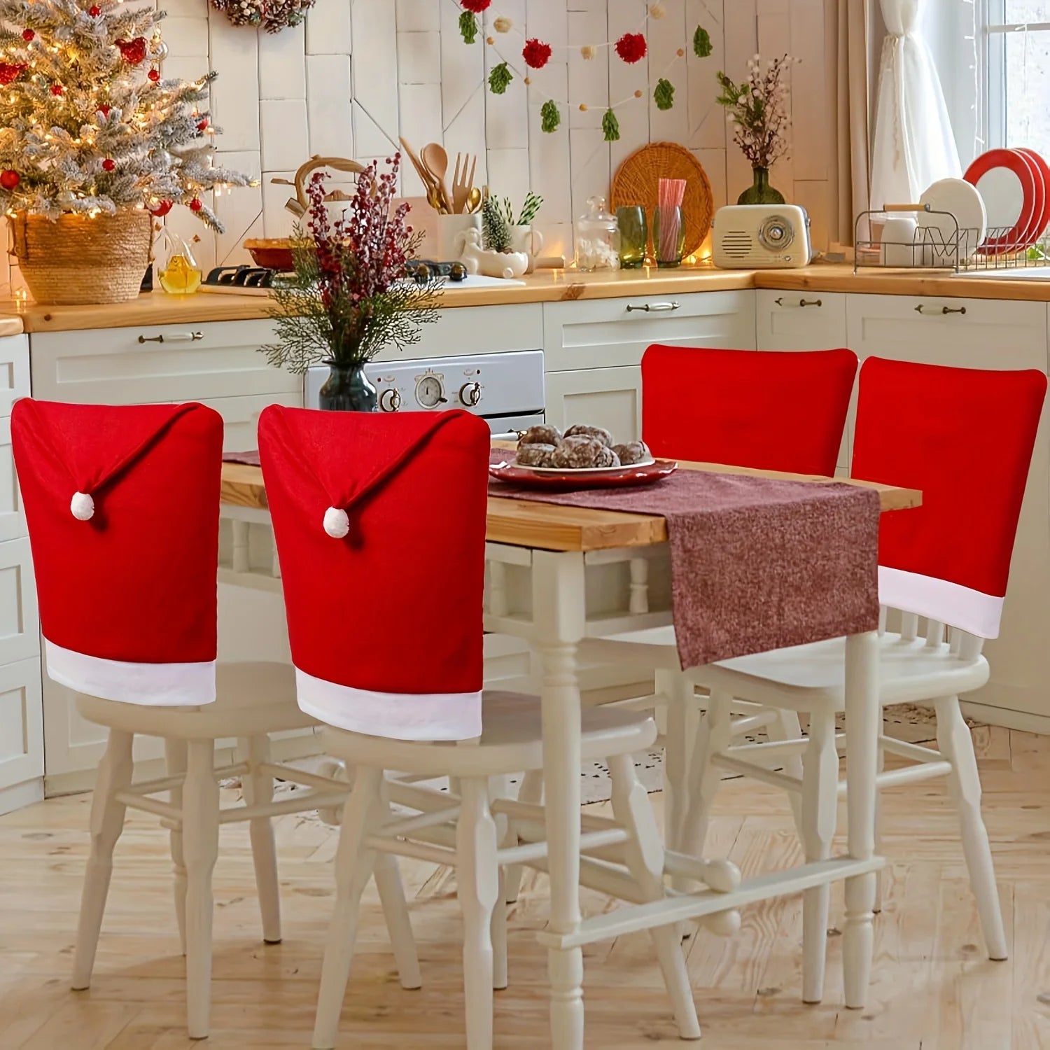 Christmas Hat Chair Covers in festive red and white, decorating a dining table for holiday celebrations