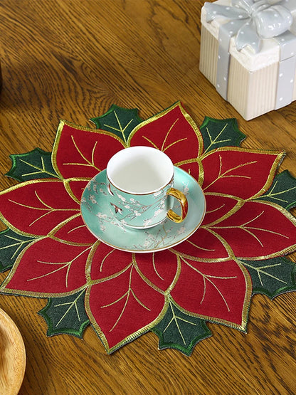 Christmas holly leaf placemat featuring a red and green design, perfect for holiday dining decor