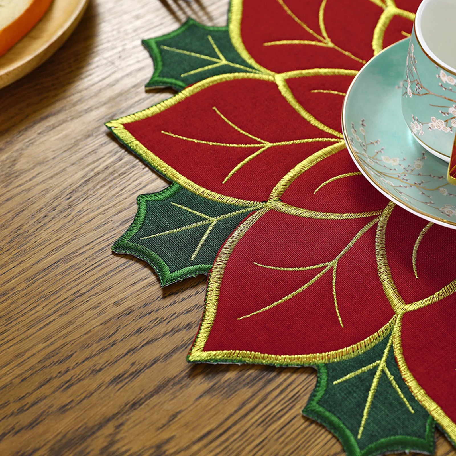 Beautiful Christmas holly leaf placemat with vibrant red and green design enhancing festive table settings