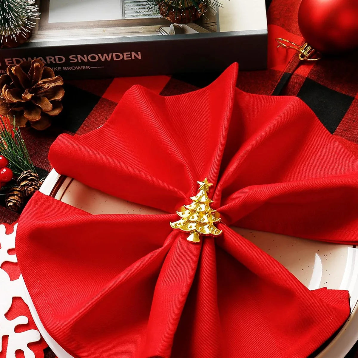 Nutshell Christmas napkin ring set featuring a decorative Christmas tree design on festive red napkins