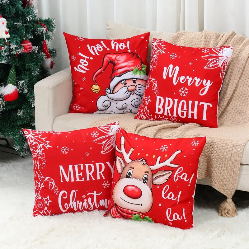 Four festive Christmas Pillow Covers featuring Santa, Rudolph, and holiday greetings in vibrant red colors