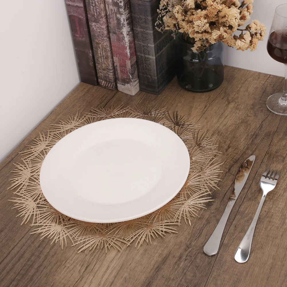 Elegant Christmas placemats in a gold burst design with a white plate and silver cutlery set