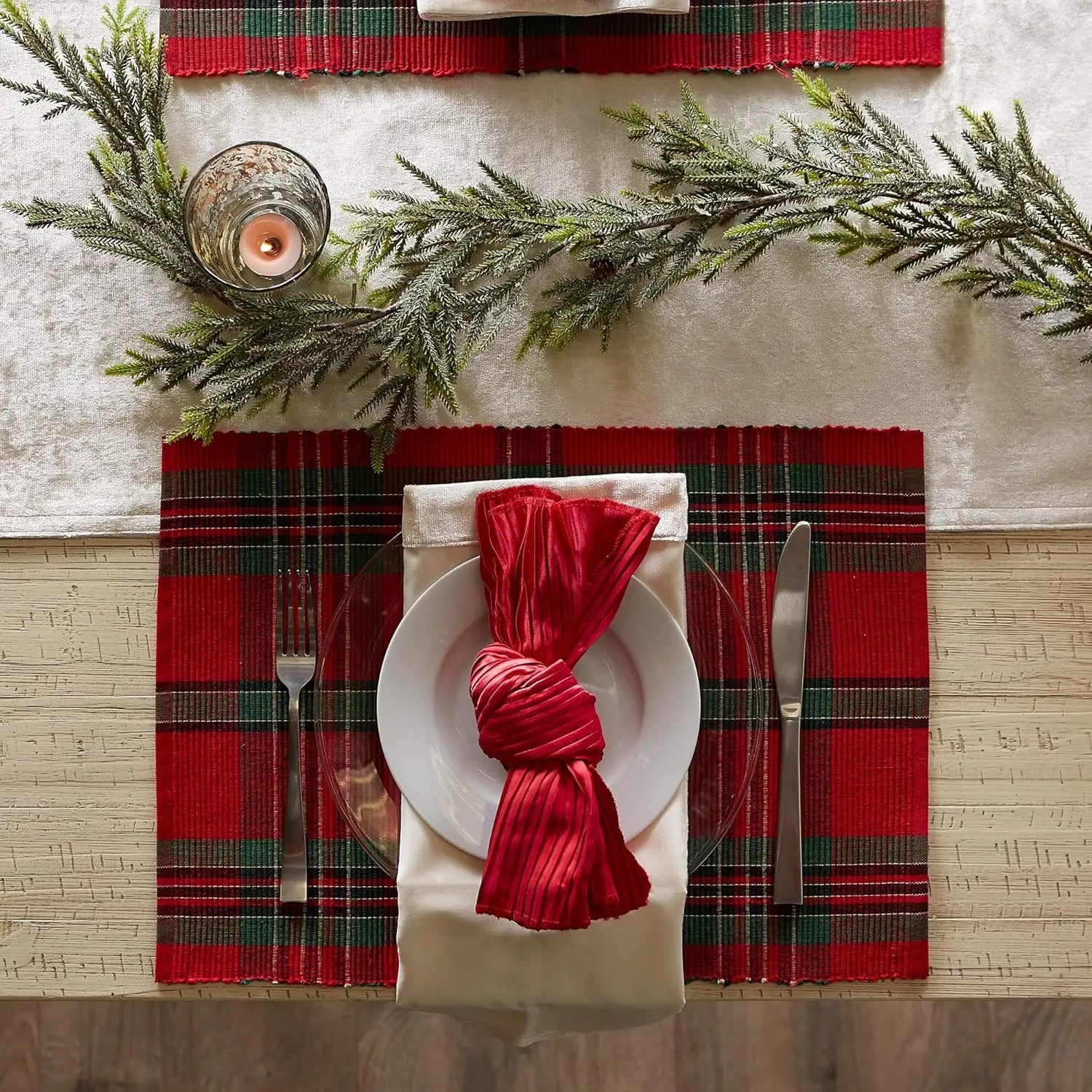 Elegant table setting with Christmas Plaid Placemats, red napkins, and holiday decor