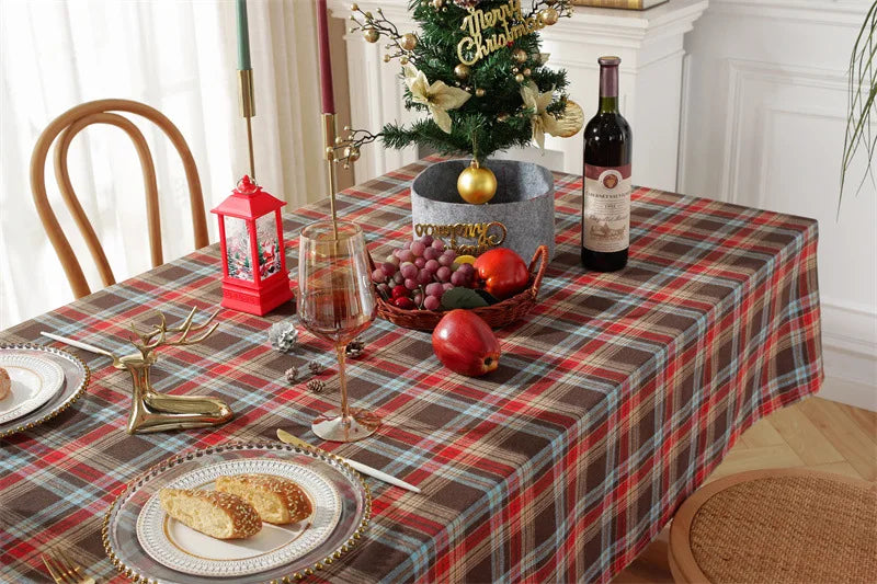 Christmas Plaid Tablecloth on a festive dining table with wine, fruit, and holiday decorations.