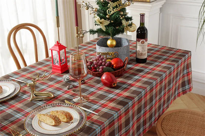 Christmas Plaid Tablecloth on a festive dining table with wine, fruit, and holiday decorations.