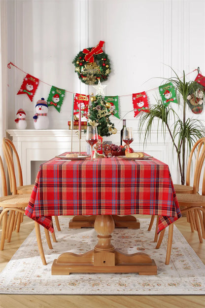 Christmas Plaid Tablecloth on a wooden dining table decorated for holiday festivities