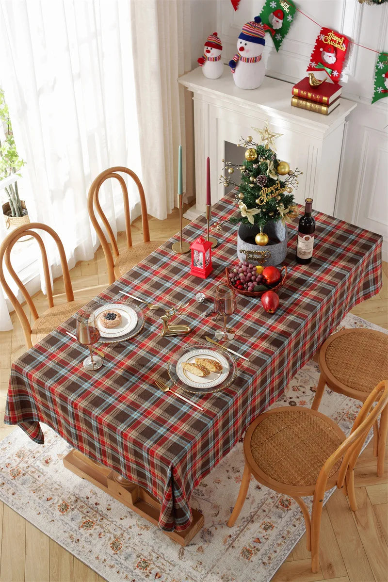 Christmas Plaid Tablecloth on a festive dining table with decorations and holiday dishes