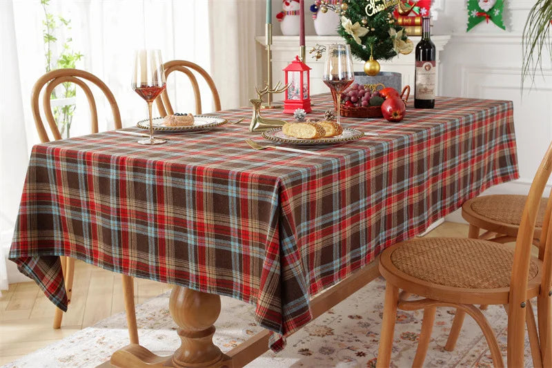 Nutshell Christmas Plaid Tablecloth on a wooden dining table decorated for a festive gathering
