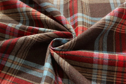 Close-up of Christmas Plaid Tablecloth with rich red, blue, and brown patterns for festive dining