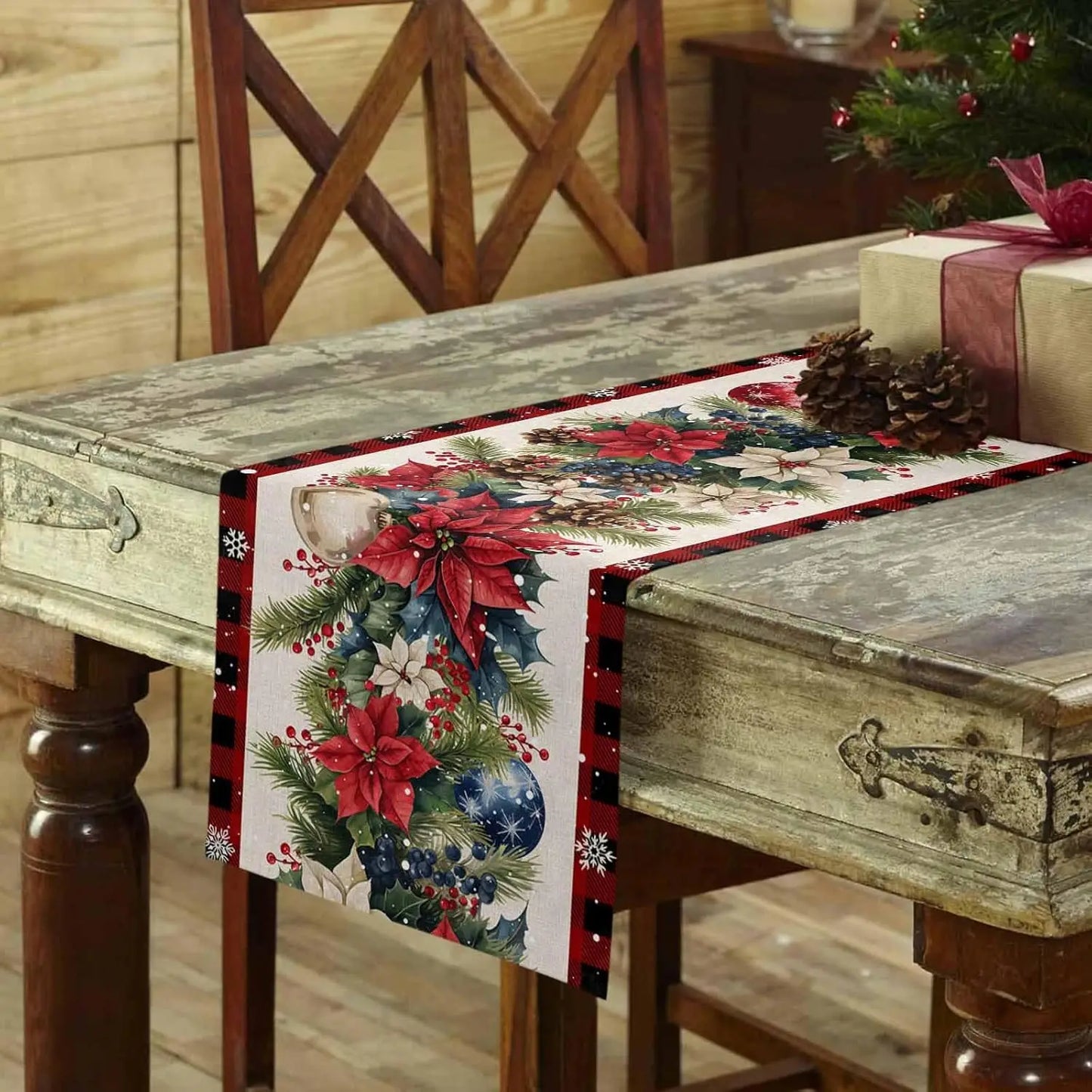 Christmas Poinsettia Flower Linen Table Runner on a rustic wooden table decorated for the holidays