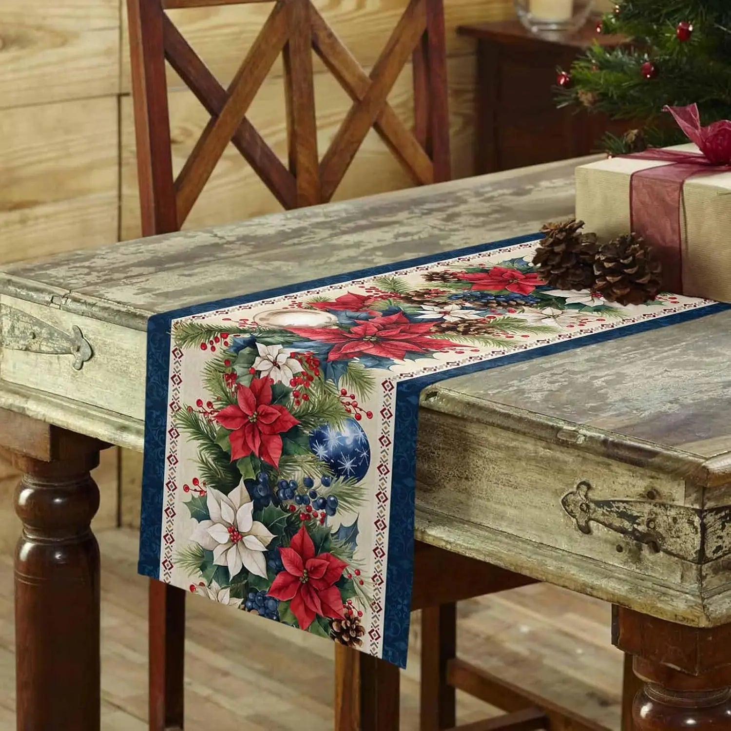 Christmas Poinsettia Flower Linen Table Runner on a rustic wood table with holiday decorations